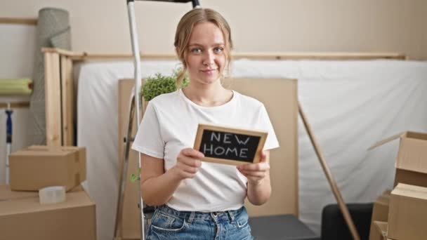 Young Blonde Woman Smiling Confident Holding Blackboard New Home — Stockvideo