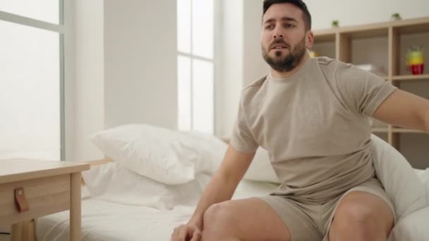 Young Hispanic Man Waking Stretching Arms Bedroom — Video Stock
