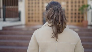 Young caucasian woman smiling confident looking at the camera at street