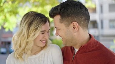 Man and woman couple smiling confident standing together at park