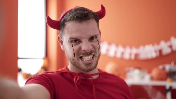 Young Caucasian Man Wearing Devil Costume Taking Selfie Picture Home — Stock video