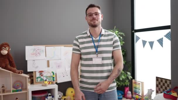 Young Caucasian Man Working Teacher Smiling Crossed Arms Kindergarten — Stockvideo