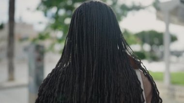 African woman smiling confident at street