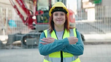 Young beautiful plus size woman architect smiling confident standing with arms crossed gesture at street