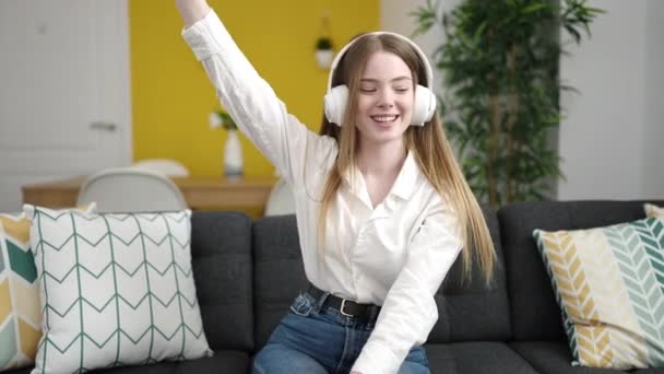 Young Blonde Woman Listening Music Sitting Sofa Home — Stockvideo