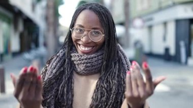 African woman smiling confident asking to come at street