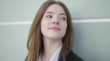 Young blonde woman smiling confident looking to the side at street