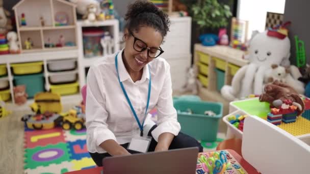 Anaokulunda Koltukta Oturan Afrikalı Amerikalı Anaokulu Öğretmeni Dizüstü Bilgisayar Kullanıyor — Stok video