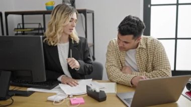 Man and woman business workers shake hands working at office