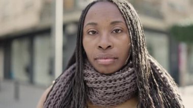 African woman smiling confident at street