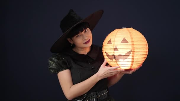Young Chinese Woman Wearing Witch Costume Holding Halloween Pumpkin Lamp — Stock video