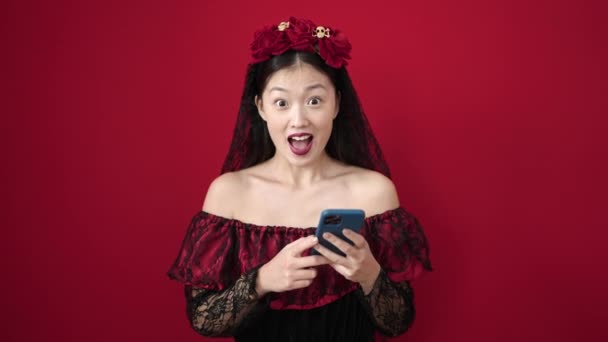 Young Chinese Woman Wearing Katrina Costume Using Smartphone Isolated Red — Vídeo de Stock
