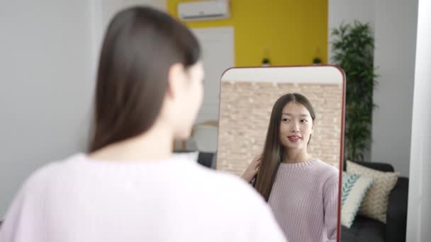 Young Chinese Woman Combing Hair Looking Mirror Bedroom — Video