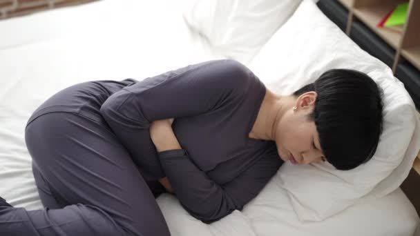 Young Chinese Woman Suffering Menstrual Pain Lying Bed Bedroom — Vídeos de Stock