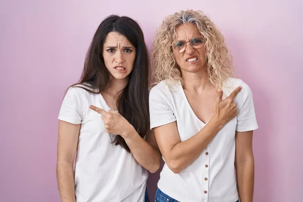 Mother Daughter Standing Together Pink Background Pointing Aside Worried Nervous — Stock Photo, Image