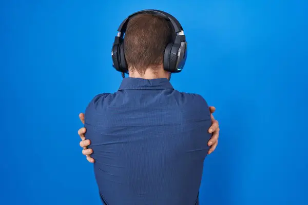 Hispanic Man Beard Listening Music Wearing Headphones Hugging Oneself Happy — Stock Photo, Image