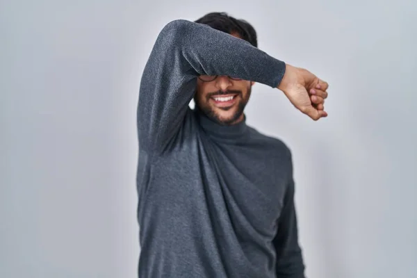Handsome Latin Man Standing Isolated Background Covering Eyes Arm Smiling — Stock Photo, Image