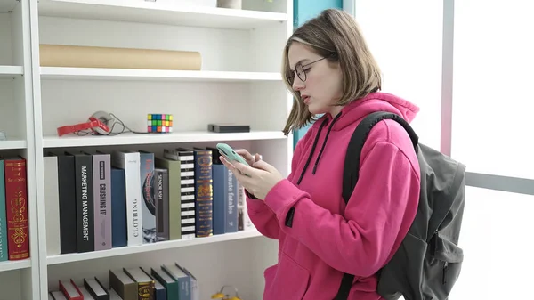 Young Blonde Woman Student Using Smartphone Library University — Foto Stock