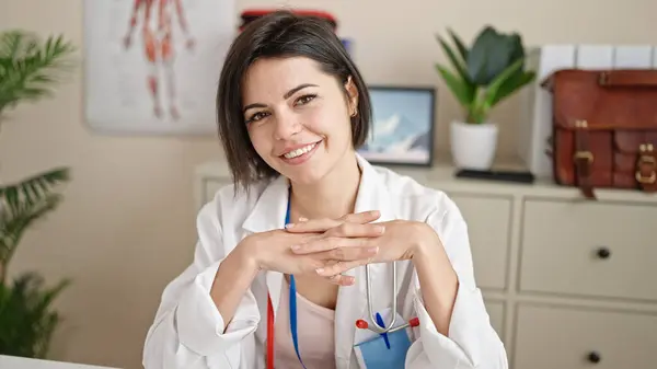 Νεαρή Καυκάσια Γυναίκα Γιατρός Κάθεται Στο Γραφείο Χαμογελώντας Στην Κλινική — Φωτογραφία Αρχείου