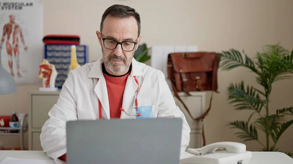 Middle Age Man Doctor Using Laptop Working Clinic — Stok fotoğraf