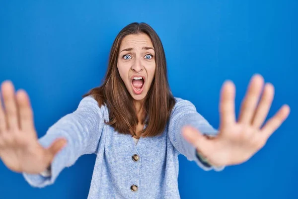 Young Woman Standing Blue Background Doing Stop Gesture Hands Palms — Stock fotografie