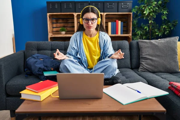 Young Hispanic Woman Studying Using Computer Laptop Headphones Skeptic Nervous — Stockfoto