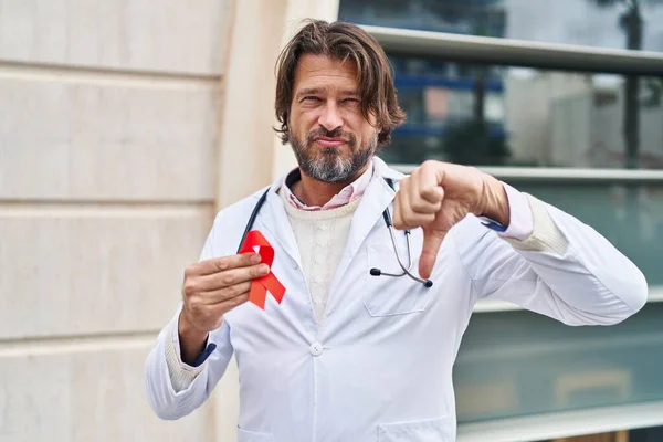 Handsome Middle Age Doctor Man Holding Support Red Ribbon Angry — Stock Photo, Image