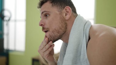 Young caucasian man tired after training at sport center