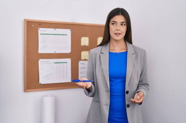 Young beautiful hispanic woman business worker speaking at office