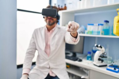Middle age man scientist using virtual reality glasses at laboratory