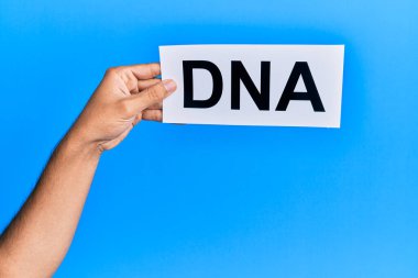 Hand of caucasian man holding paper with dna word over isolated white background