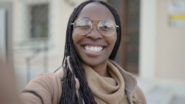 African woman taking selfie smiling at street