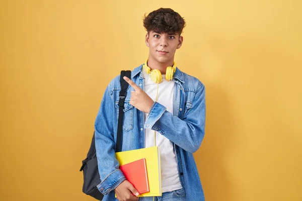 Ισπανόφωνος Έφηβος Φορώντας Σακίδιο Μαθητή Και Κρατώντας Βιβλία Δείχνοντας Στην — Φωτογραφία Αρχείου