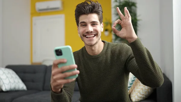 Young Hispanic Man Using Smartphone Doing Gesture Home — 스톡 사진