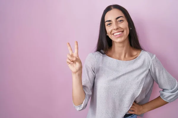 Young Brunette Woman Standing Pink Background Smiling Happy Face Winking — Fotografia de Stock