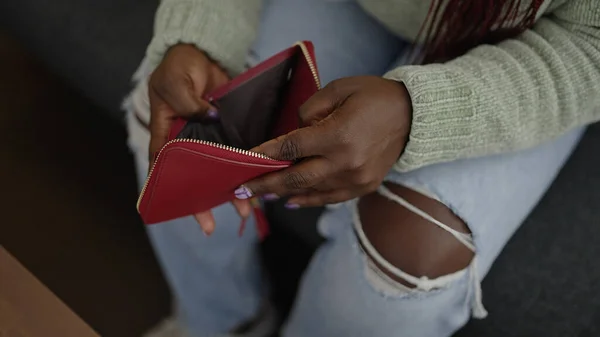 stock image African woman with braided hair showing empty wallet at home