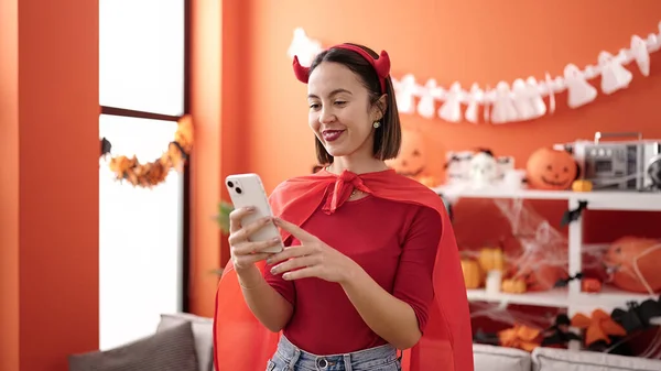 Young Beautiful Hispanic Woman Wearing Devil Costume Using Smartphone Home —  Fotos de Stock