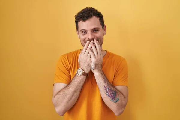 Young Hispanic Man Standing Yellow Background Laughing Embarrassed Giggle Covering — Stock fotografie