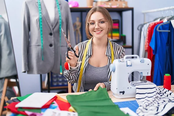 Young Blonde Woman Tailor Smiling Confident Cutting Cloth Tailor Shop — Stock Photo, Image