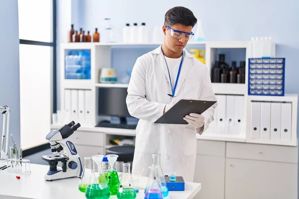 Young Hispanic Man Scientist Writing Report Working Laboratory — Stock Photo, Image