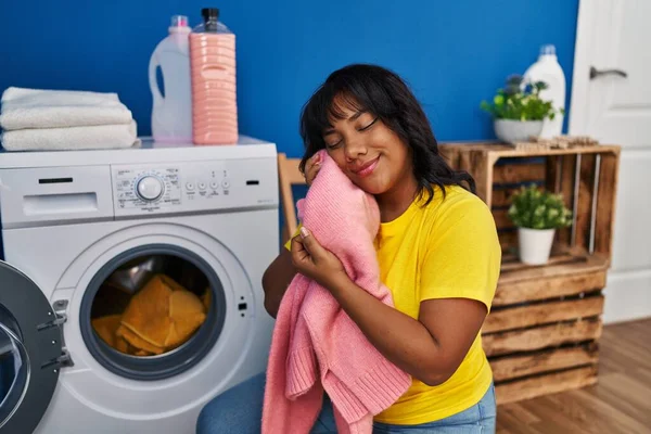 Young Beautiful Latin Woman Washing Clothes Touching Face Soft Sweater — Stok fotoğraf