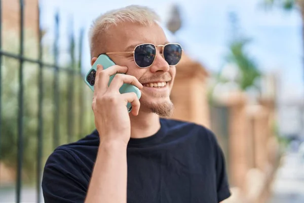 stock image Young caucasian man smiling confident talking on smartphone at street