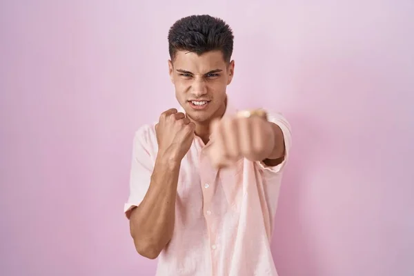 Young Hispanic Man Standing Pink Background Punching Fist Fight Aggressive — Stock fotografie