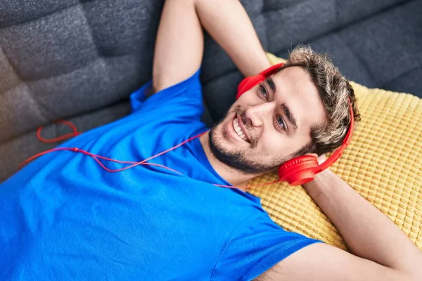 Young Man Listening Music Lying Sofa Home — Stockfoto