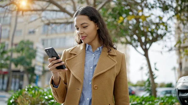 stock image Young beautiful hispanic woman using smartphone smiling at park