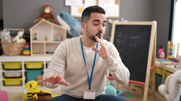 Young Hispanic Man Preschool Teacher Asking Silence Kindergarten — Stock fotografie