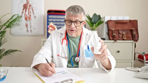 Middle Age Grey Haired Man Doctor Prescribing Pills Clinic — Stock Photo, Image