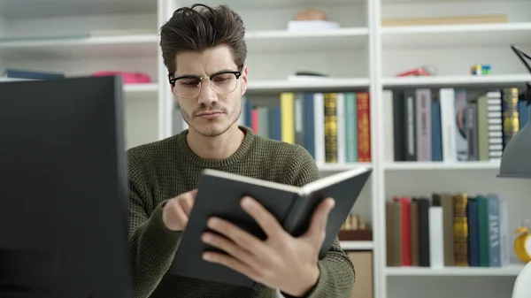 Young Hispanic Man Student Reading Book Studying Library University — Foto de Stock