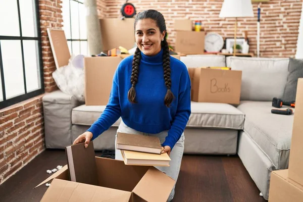 Young Hispanic Woman Smiling Confident Packaging Books Package New Home — Stok fotoğraf