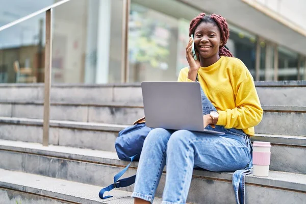 African American Woman Student Using Laptop Talking Smartphone University — Stockfoto